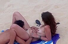 Naturists couples enjoy there sunbath in the nude beach